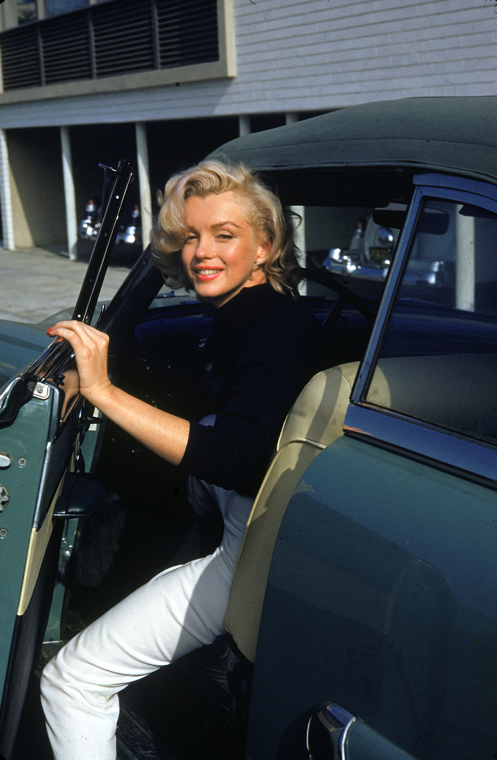 Monroe getting out of a car.