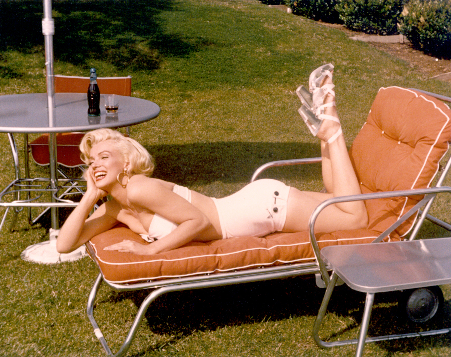 Circa 1953, Monroe poses in a bathing suit and heels.