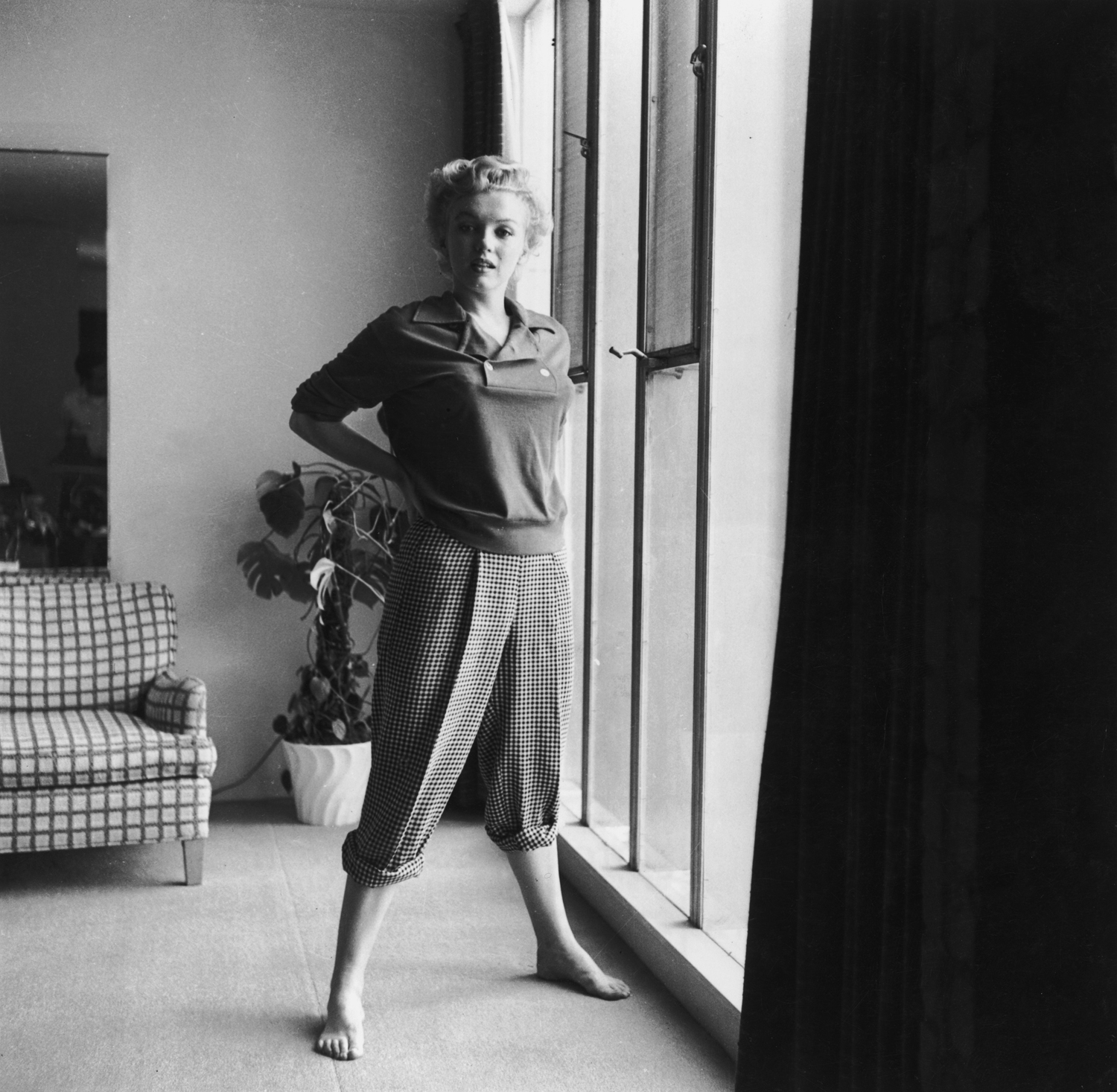 Monroe in a sweater and pants in 1955.