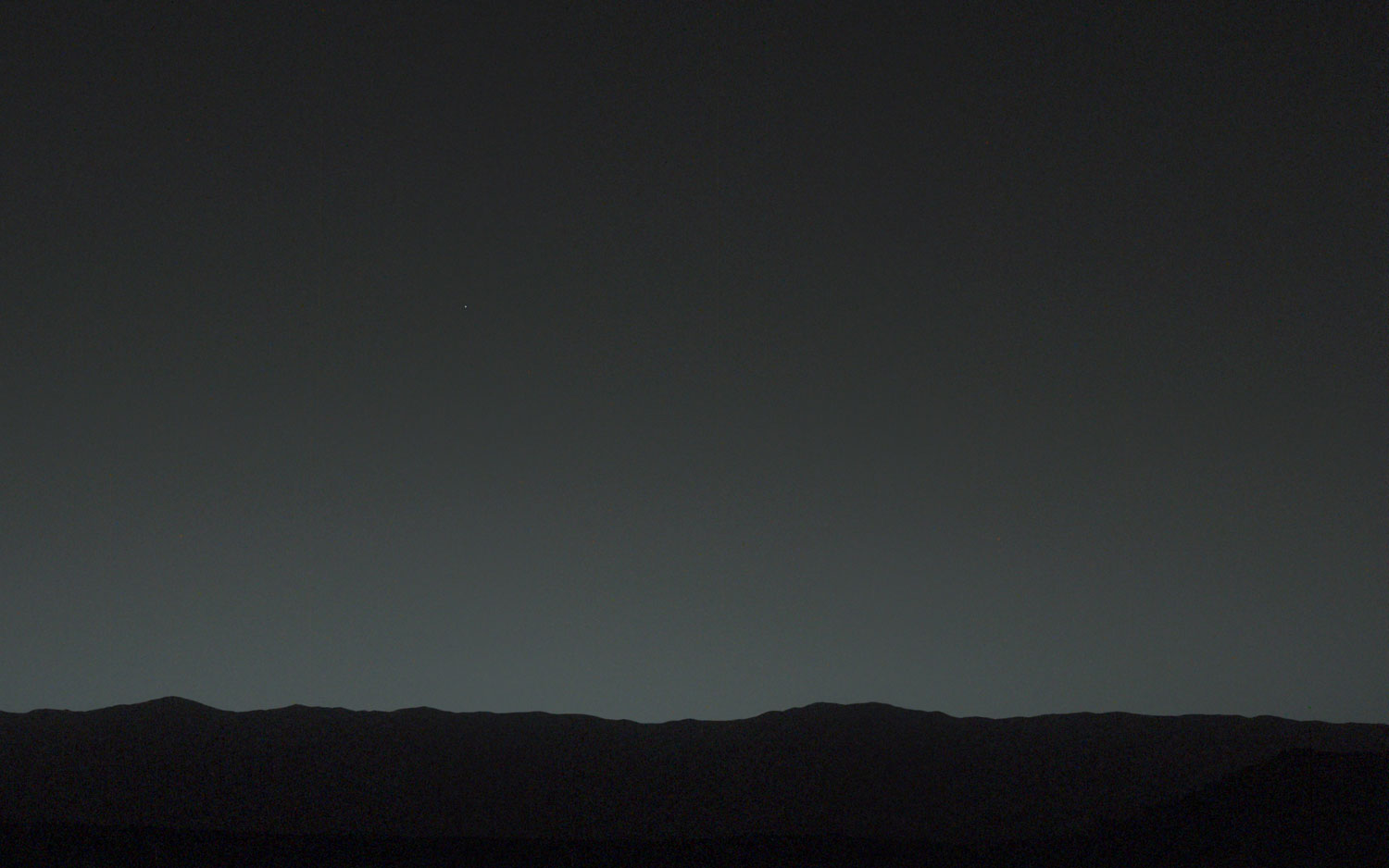 This view of the twilight sky and the Martian horizon taken by NASA's Curiosity Mars rover includes Earth as the brightest visible point of light, a little left of center in the image. The moon is just below it.  The picture was released on Feb. 6, 2014.