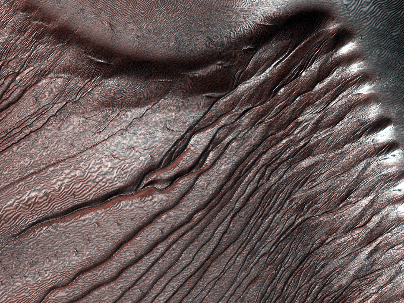 An image from orbit of the Russell Crater dunes on Mars, released on Feb. 5, 2014. Pictures like this help astronomers measure the accumulation of frost year after year in the fall, and its disappearance in the spring. The frost is carbon dioxide ice that often sublimates (going directly from a solid to a gas) during the Martian spring.