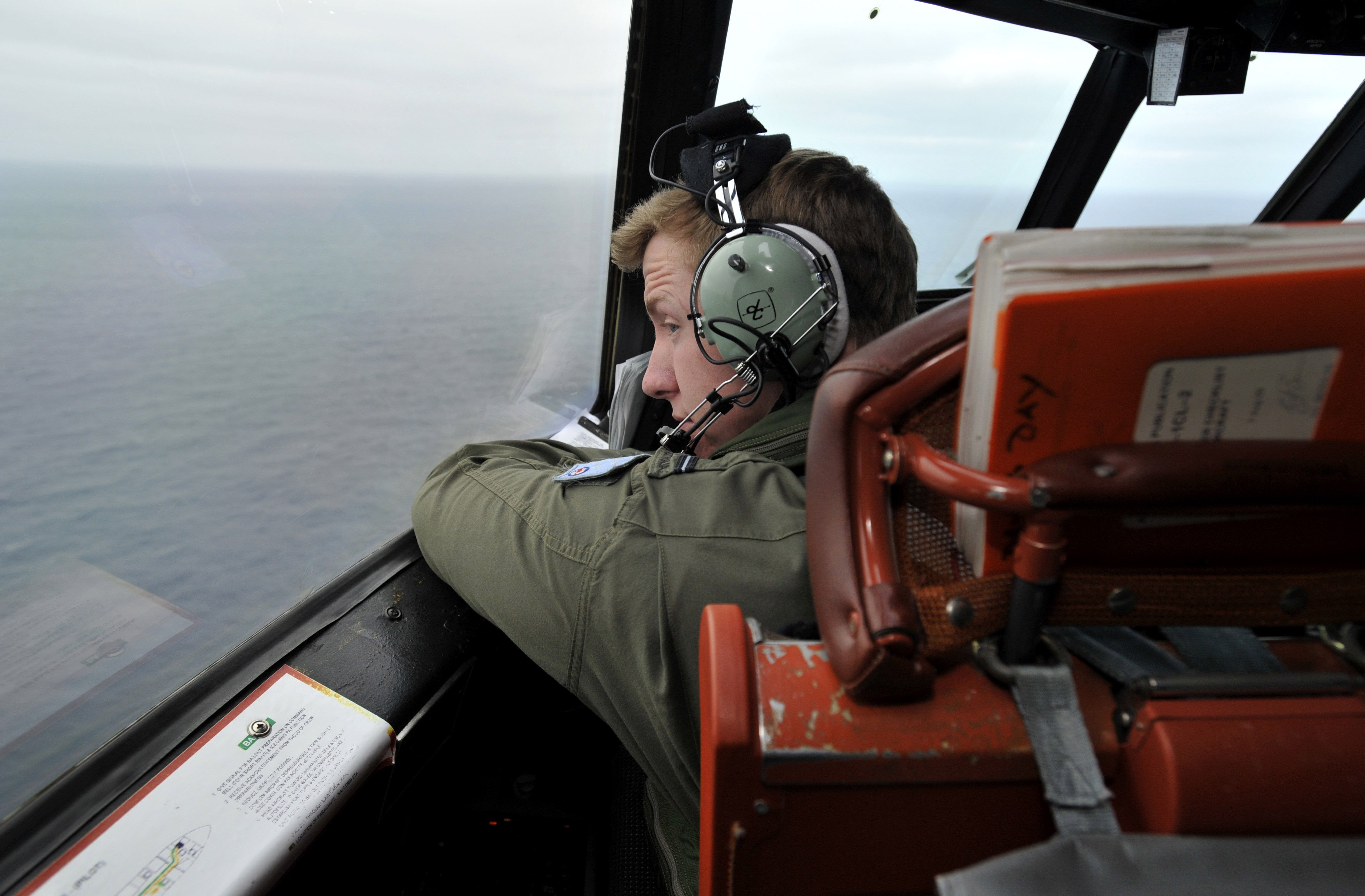 Flying Officer Benjamin Hepworth searches from a Royal Australian Airforce AP-3C Orion from Pearce Airforce Base during a search mission for possible MH370 debris on March 21, 2014 in Perth, Australia.