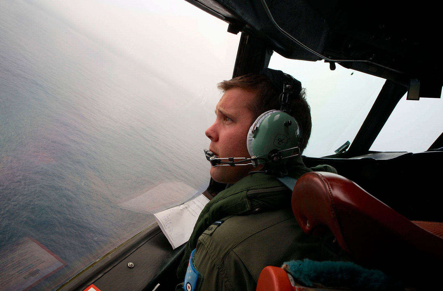 Co-Pilot, Flying Officer Marc Smith, turns his Royal Australian Air Force (RAAF) AP-3C Orion aircraft at low level in bad weather whilst searching for the missing Malaysian Airlines Flight MH370 over the southern Indian Ocean March 24, 2014.