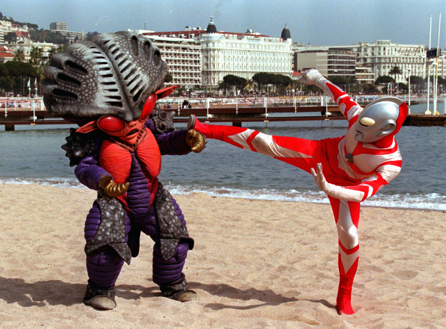 Japanese characters Ultraman, right, and Alien Benzene stage a fight on the French Riviera