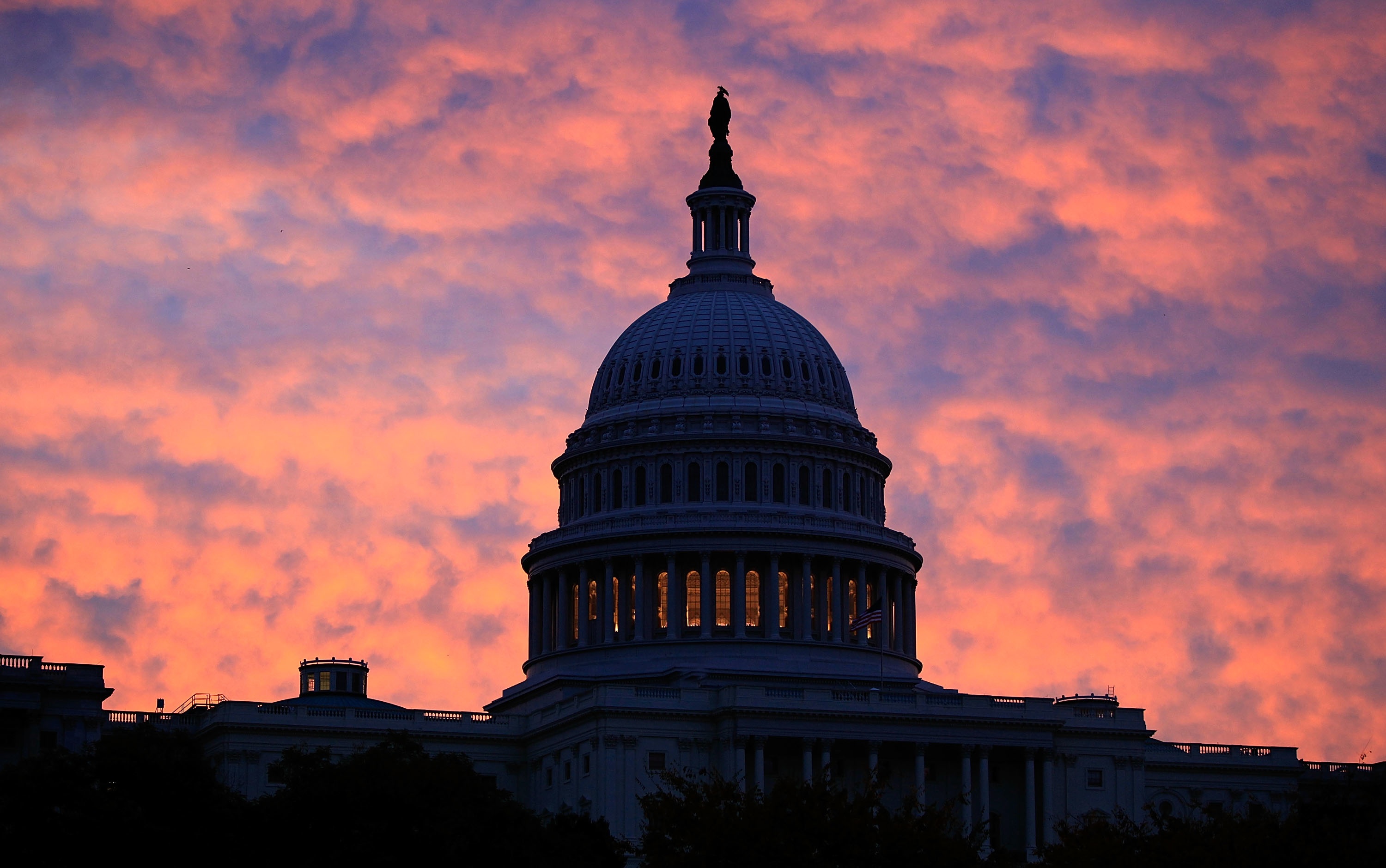 The early morning sun rises behind the US Capitol Building in Washington, DC. (Mark Wilson—Getty Images)