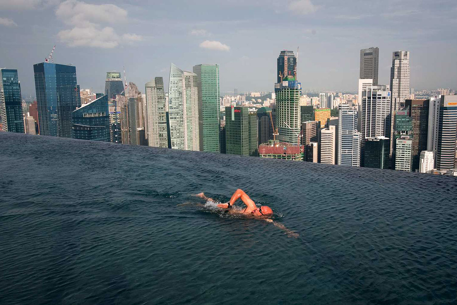 A guest swims in the infinity pool of the Skypark that tops the Marina Bay Sands hotel towers in Singapore June 24, 2010 (Vivek Prakash / Reuters)