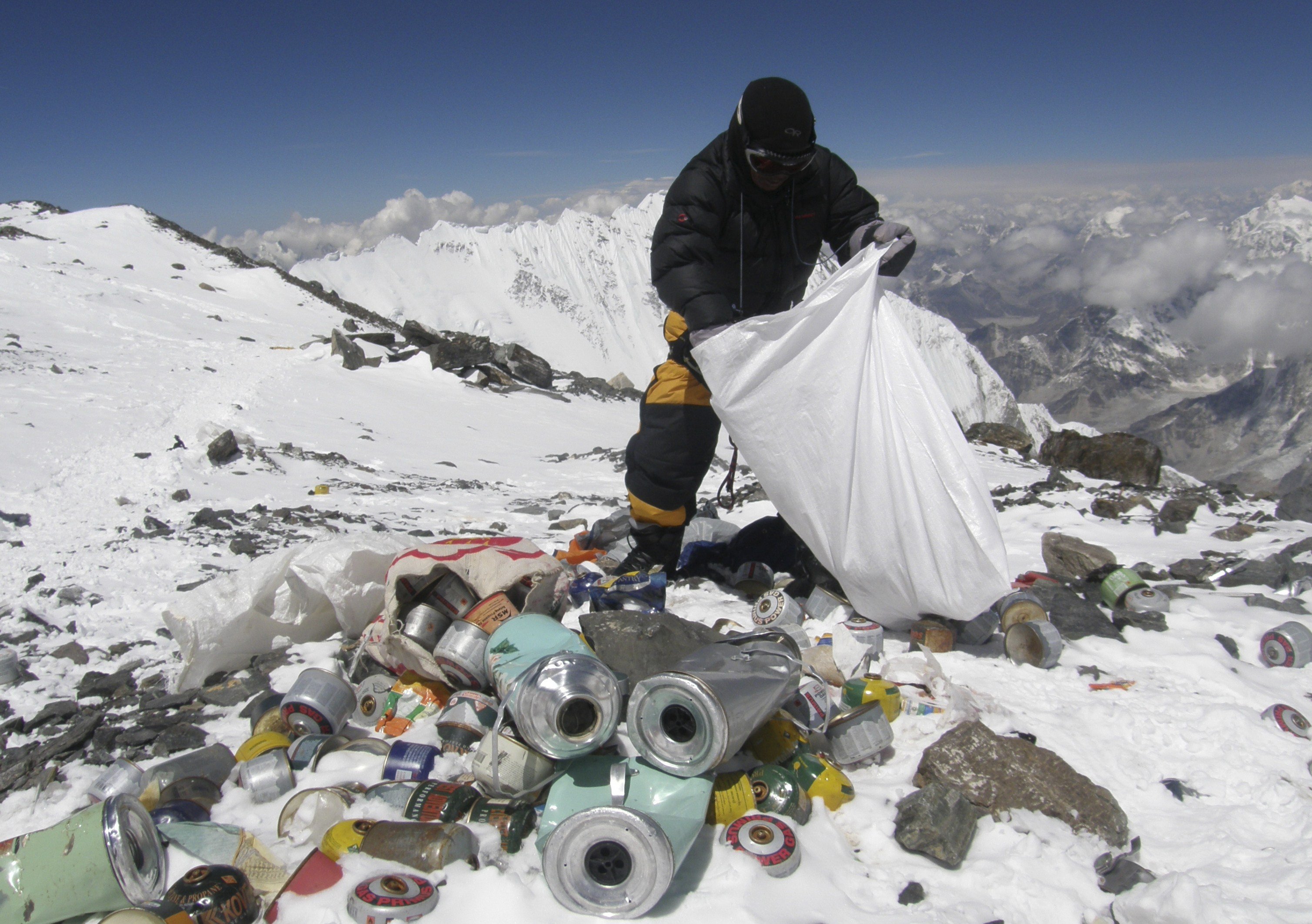 A Nepalese sherpa collects garbage left by climbers at an altitude of 8,000 metres during the Everest clean-up expedition at Mount Everest, on May 23, 2010. (Namgyal Sherpa—AFP/Getty Images)