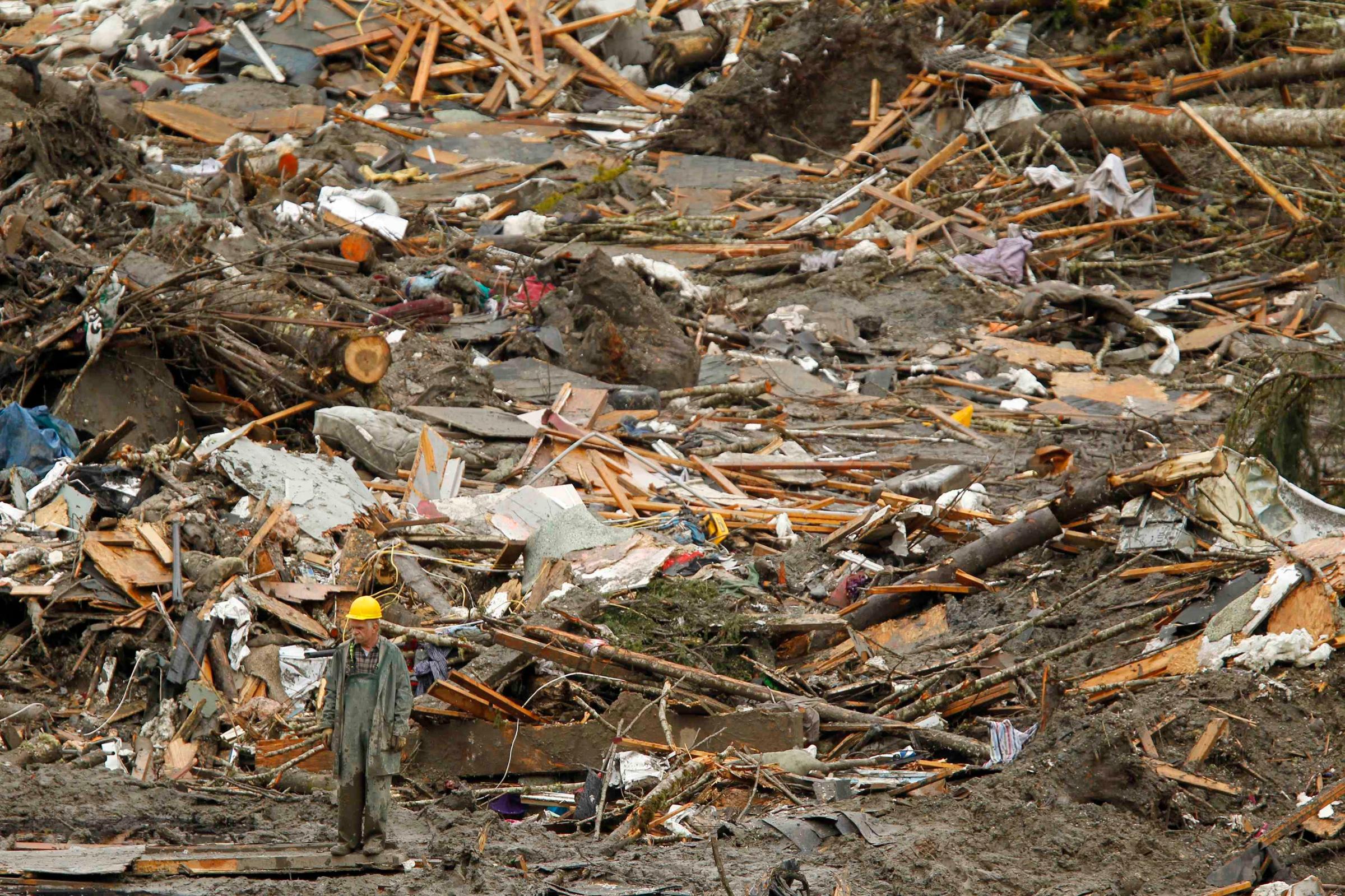 Rescue worker looks over the debris pile from the mudslide in Oso