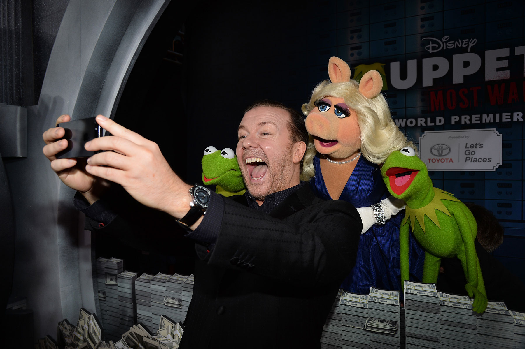 Ricky Gervais takes a selfie with his castmates from Muppets Most Wanted during the movie's premiere at the El Capitan Theatre on March 11, 2014 in Hollywood, Ca.