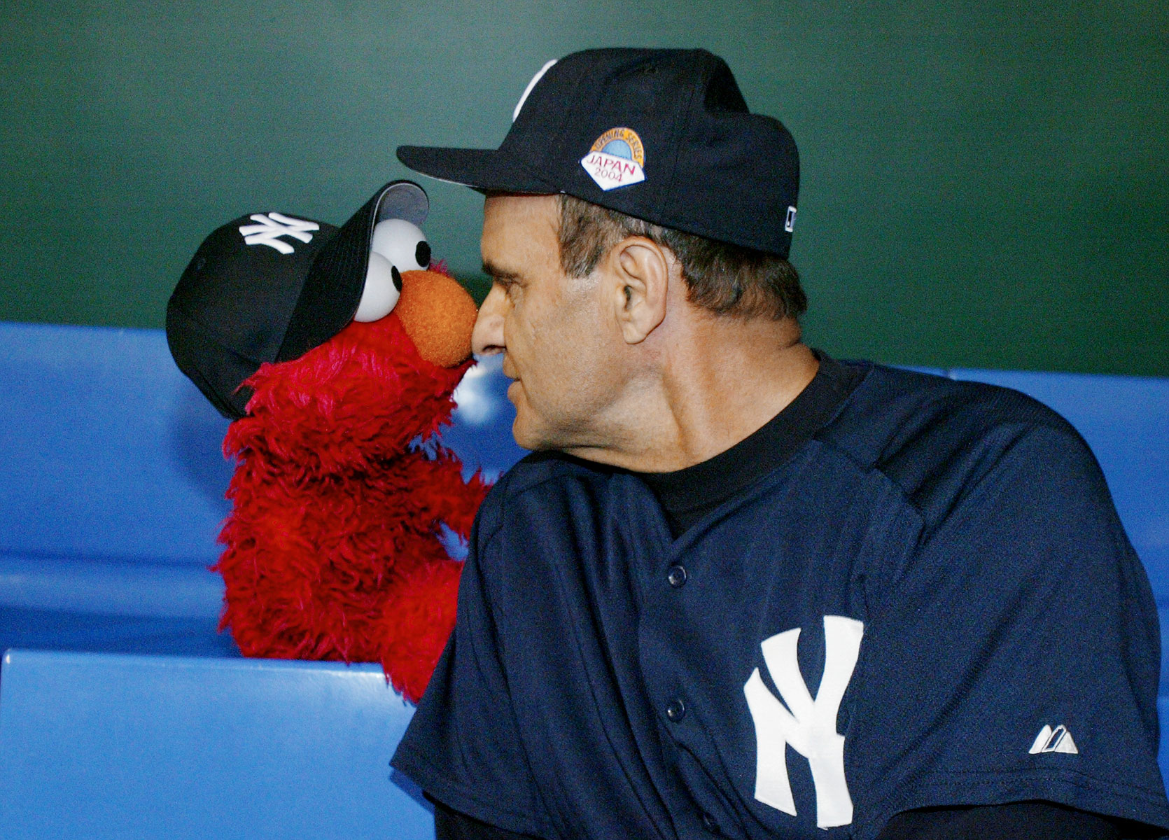 New York Yankees' manager Joe Torre and Elmo compare noses before an exhibition game against Hideki Matsui's former team, the Yomiuri Giants, at the Tokyo Dome in Tokyo, Japan.