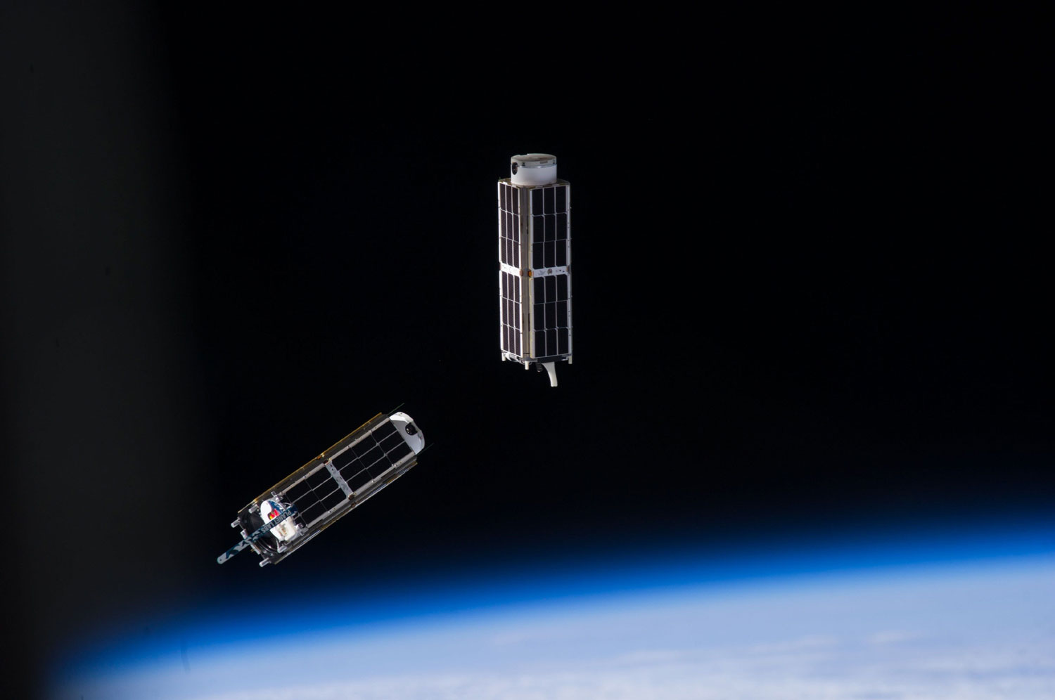 A set of NanoRacks CubeSats float in space after the deployment by the International Space Station on Feb. 13, 2014.
