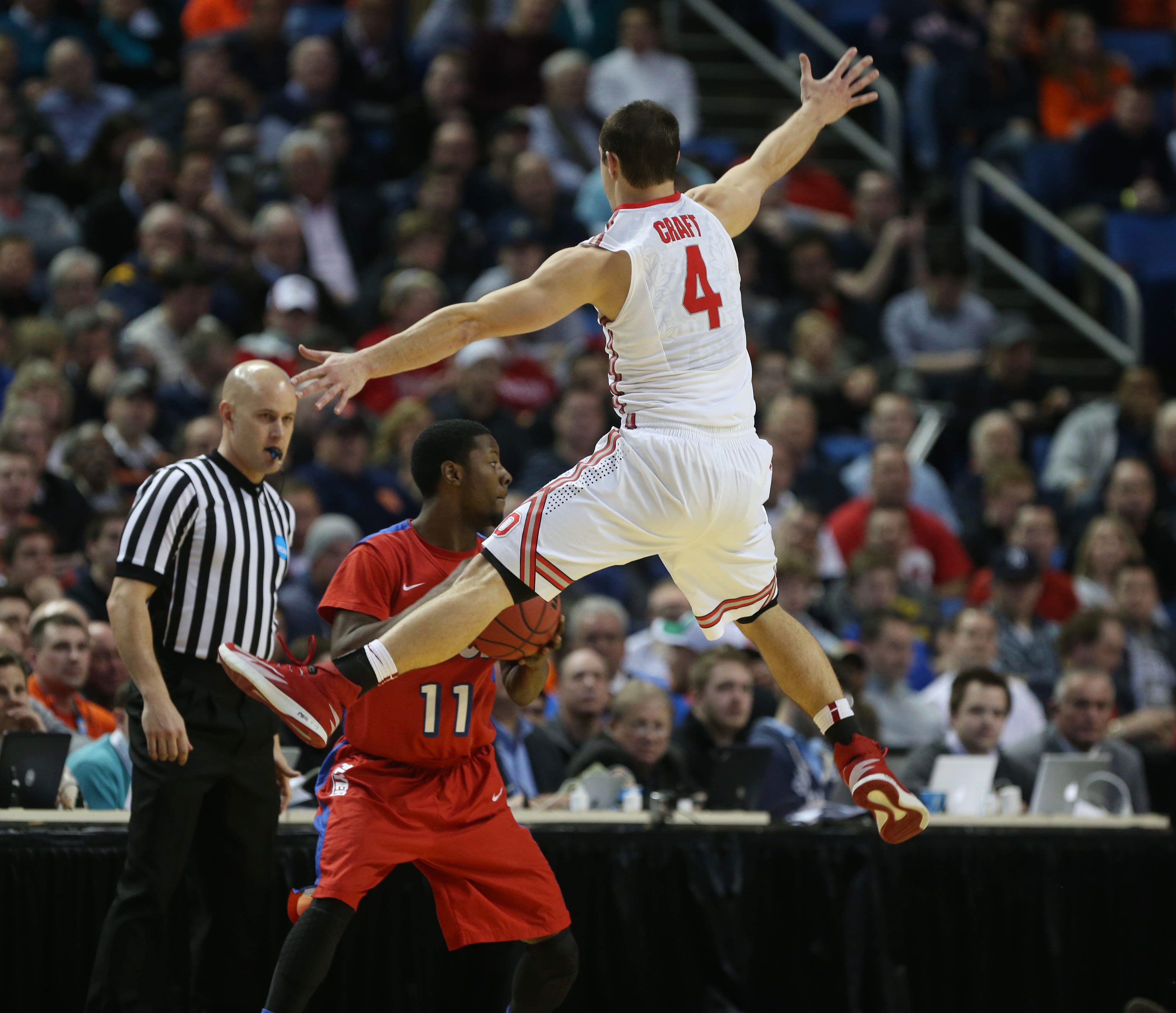 Ohio State's Aaron Craft (4) defends as Dayton's Scoochie Smith (11) tries to inbound the ball during the second half of a second-round game of the NCAA college basketball tournament in Buffalo, N.Y., Thursday, March 20, 2014. (Robert Kirkham—Buffalo News / AP)