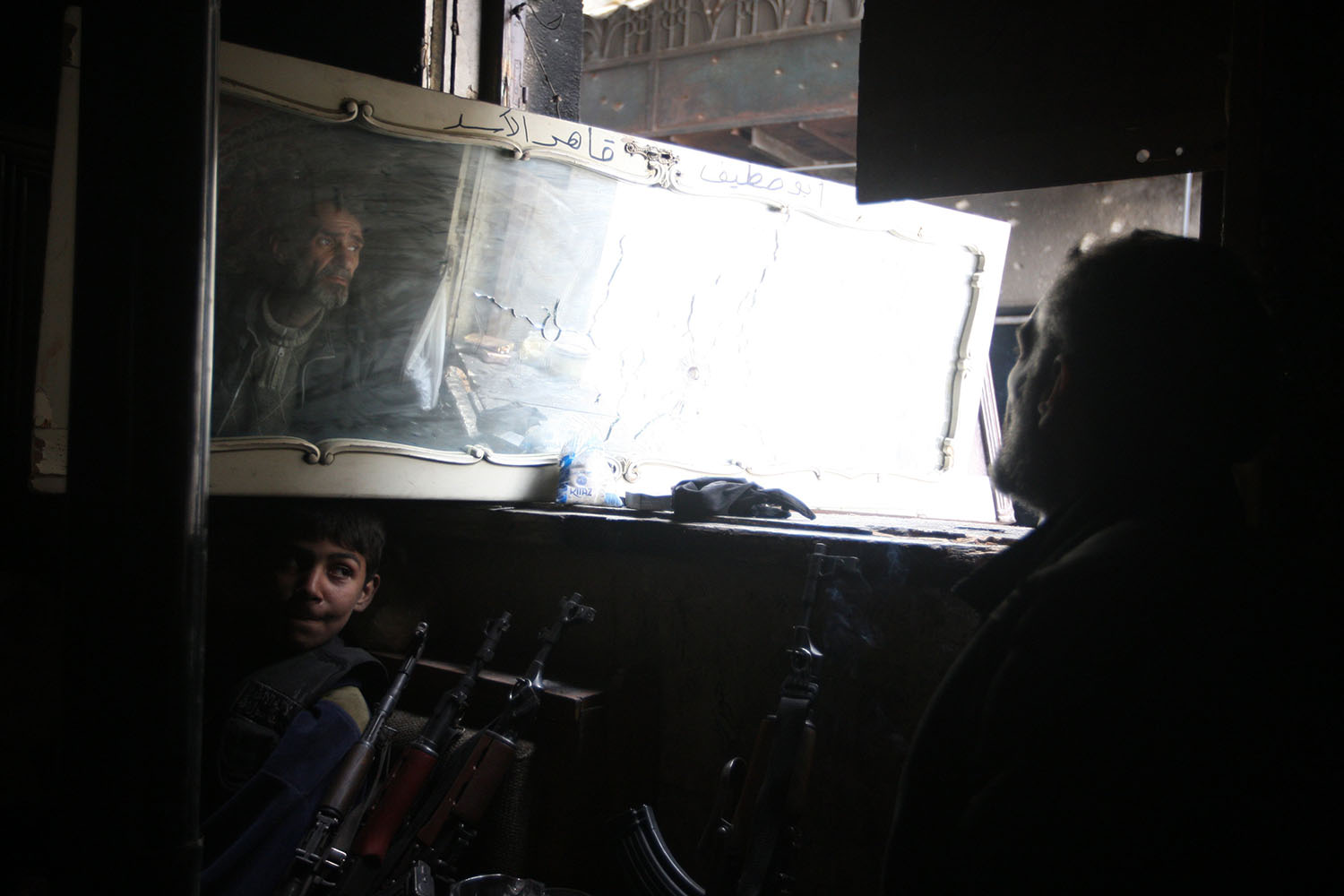 Mar. 3, 2014. A rebel fighter monitors through a miror the location of pro-regime fighters in the northern Syrian city of Aleppo.