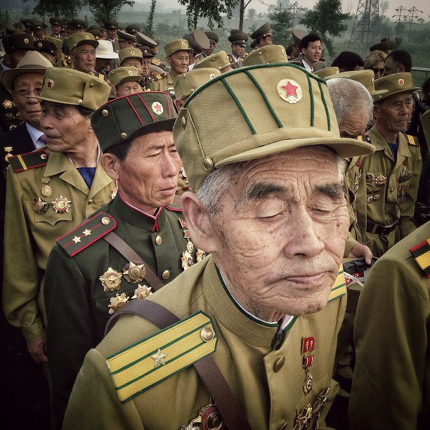 Korean War veterans enter a cemetery for their deceased fellow war veterans in Pyongyang, July 24, 2013.