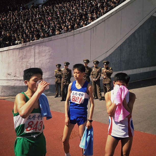 North Korean runners rest at the finish line of the 26th Mangyongdae Prize Marathon in Pyongyang, Kim Il-Sung Stadium, April 14, 2013.