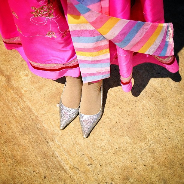 Glittery silver heels and a traditional dress as colorful as an Easter egg, Pyongyang, April 10, 2013.