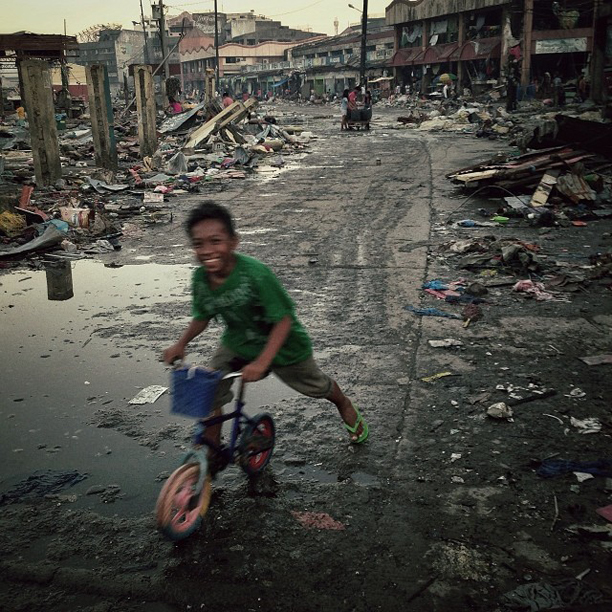 A boy plays in the street in the Typhoon Haiyan destroyed town of Tacloban, Philippines, November 17, 2013.