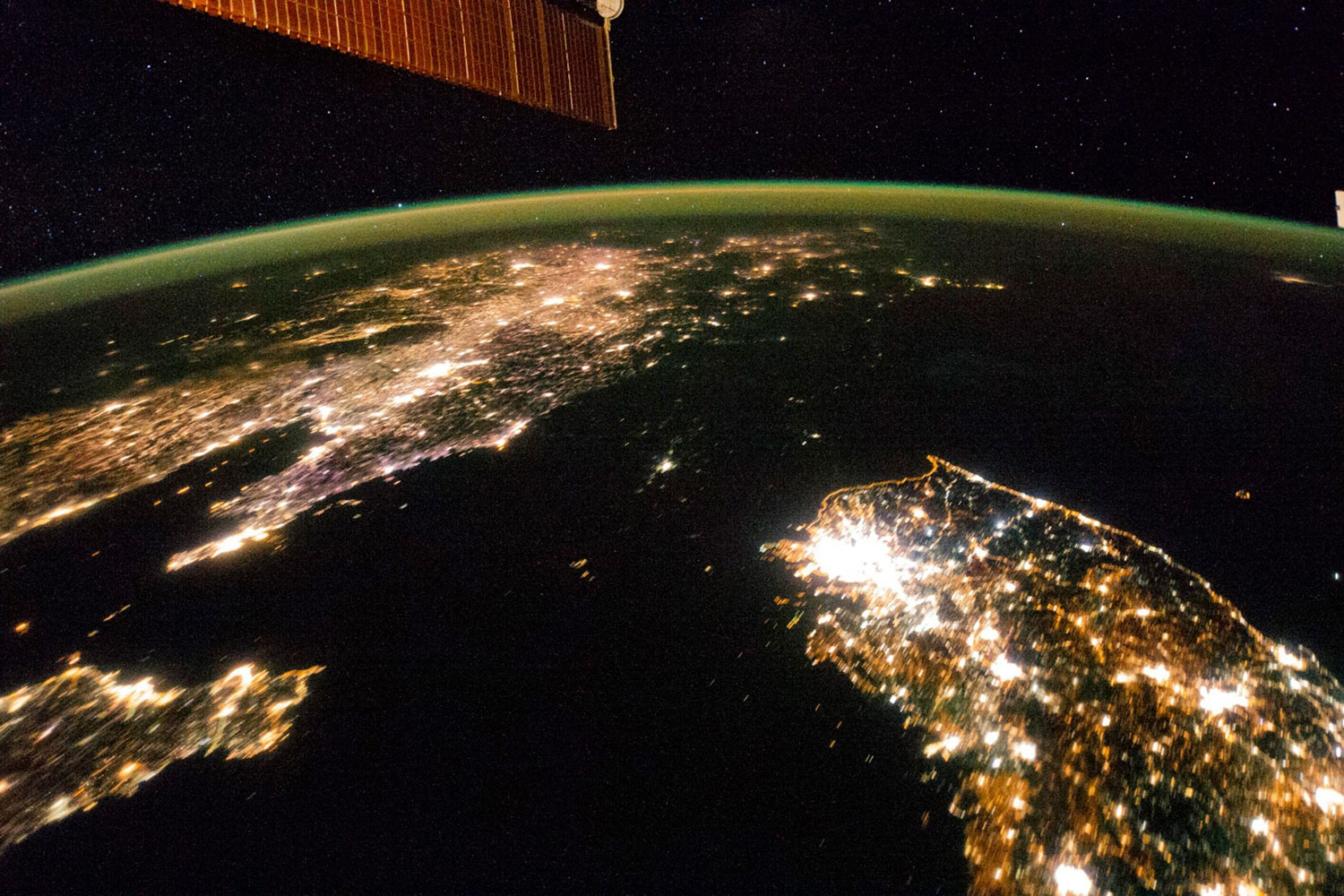 A NASA image released on February 24, 2014 shows a photo taken by the Expedition 38 crew aboard the International Space Station (ISS) on January 30, 2014, of the night view of the Korean Peninsula. The dark stretch in the middle is North Korea, with only the capital, Pyongyang, lit. Neighboring South Korea (bottom right) and China (top left) blaze with light.
