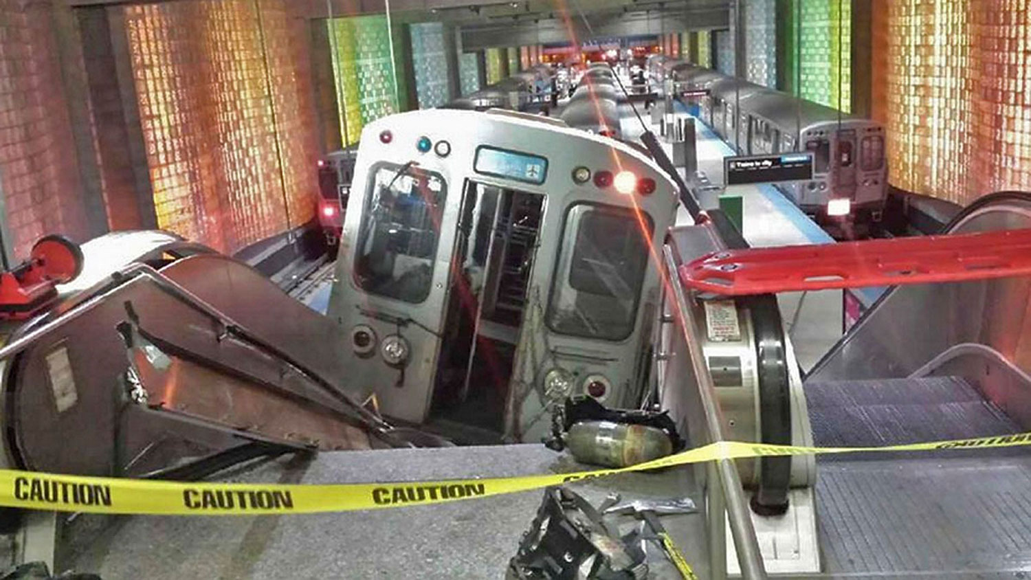 A handout photo shows a derailed commuter train resting on an escalator at O'Hare international airport in Chicago