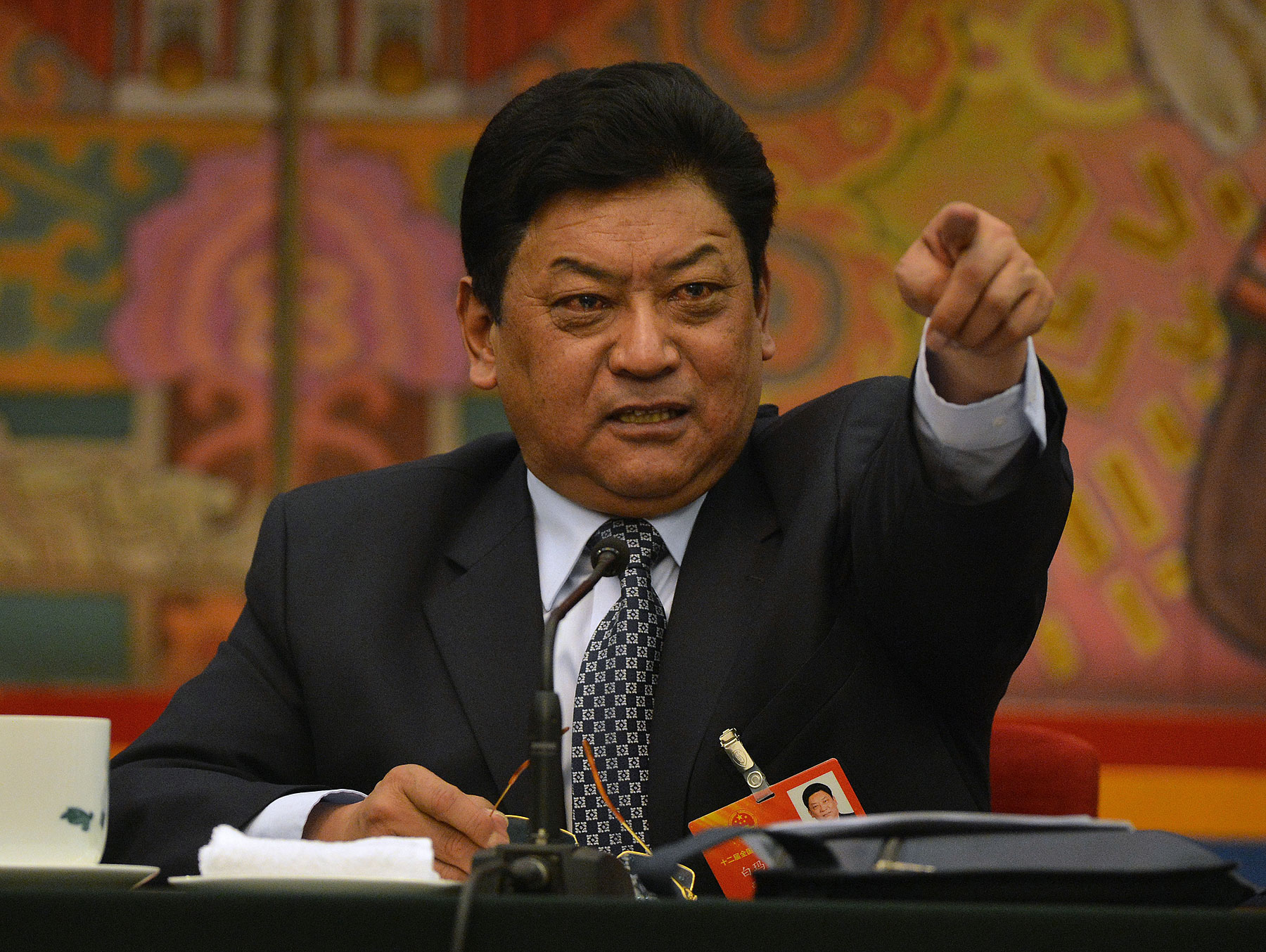 Padma Choling, head of China's Tibet Autonomous Region Congress gestures during their open session in the Great Hall of the people at the National People's Congress in Beijing on March 8, 2013 (Mark Ralston—AFP/Getty Images)