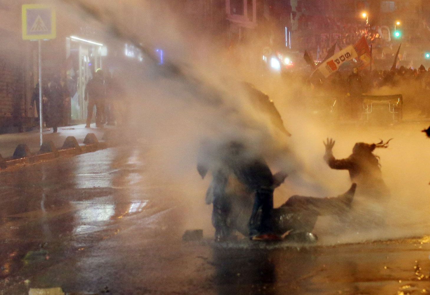 Protesters are hit by water cannon during clashes with riot police in Kadikoy, on the Anatolian side of Istanbul, on March 11, 2014.