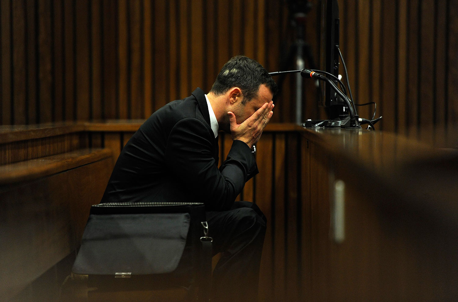 Olympic and Paralympic track star Oscar Pistorius reacts during the fourth day of his trial for the murder of his girlfriend Reeva Steenkamp at the North Gauteng High Court in Pretoria, March 6, 2014.  