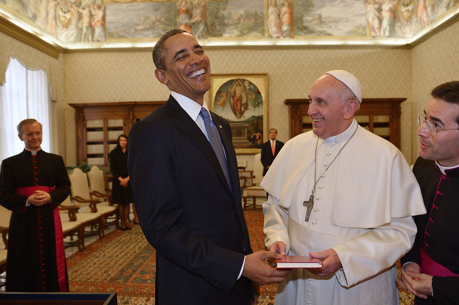 President Barack Obama and Pope Francis exchange gifts during a private audience on March 27, 2014 at the Vatican.
