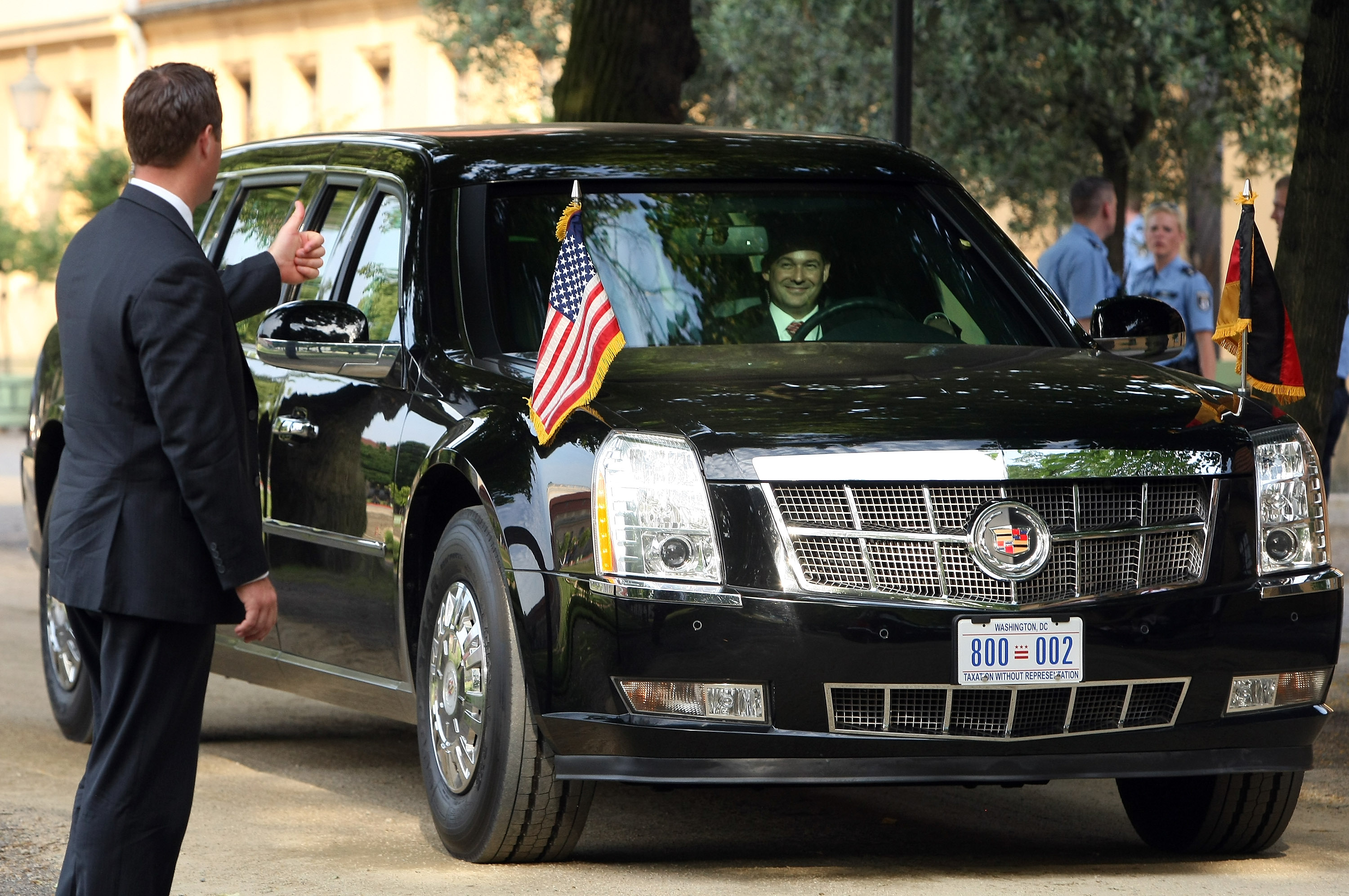 A security officer gives a thumbs-up to the driver of 'The Beast,' a modified Cadillac DTS that is the current U.S. presidential limousine, after U.S. President Barack Obama exited it for a dinner at the Orangerie at Schloss Charlottenburg palace on June 19, 2013 in Berlin. (Adam Berry—Getty Images)