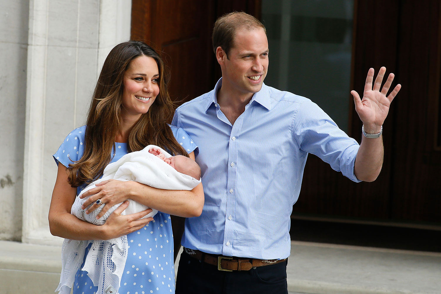 Prince William, right, and Kate, Duchess of Cambridge, hold the Prince of Cambridge, as they pose for photographers outside St. Mary's Hospital in London, July 23, 2013. (Kirsty Wigglesworth&mdash;AP)