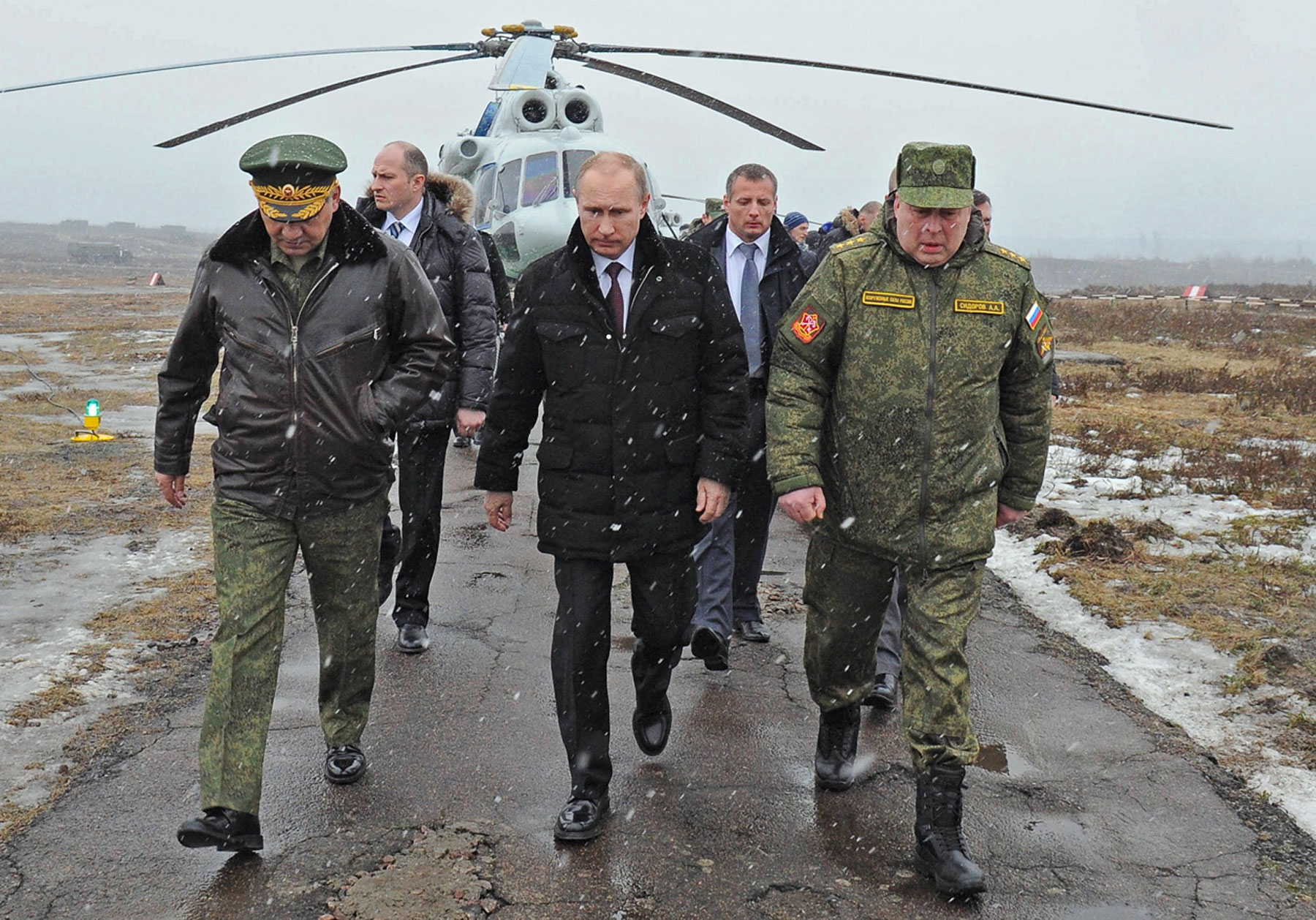 From left: Russia's defence minister Sergei Shoigu, president Vladimir Putin, and commander of the Russian Western Military District Troops Anatoly Sidorov arrive at the Kirillovsky training ground to watch military exercises on Mar.3, 2014. (Klimentyev Mikhail—ITAR-TASS/Landov)