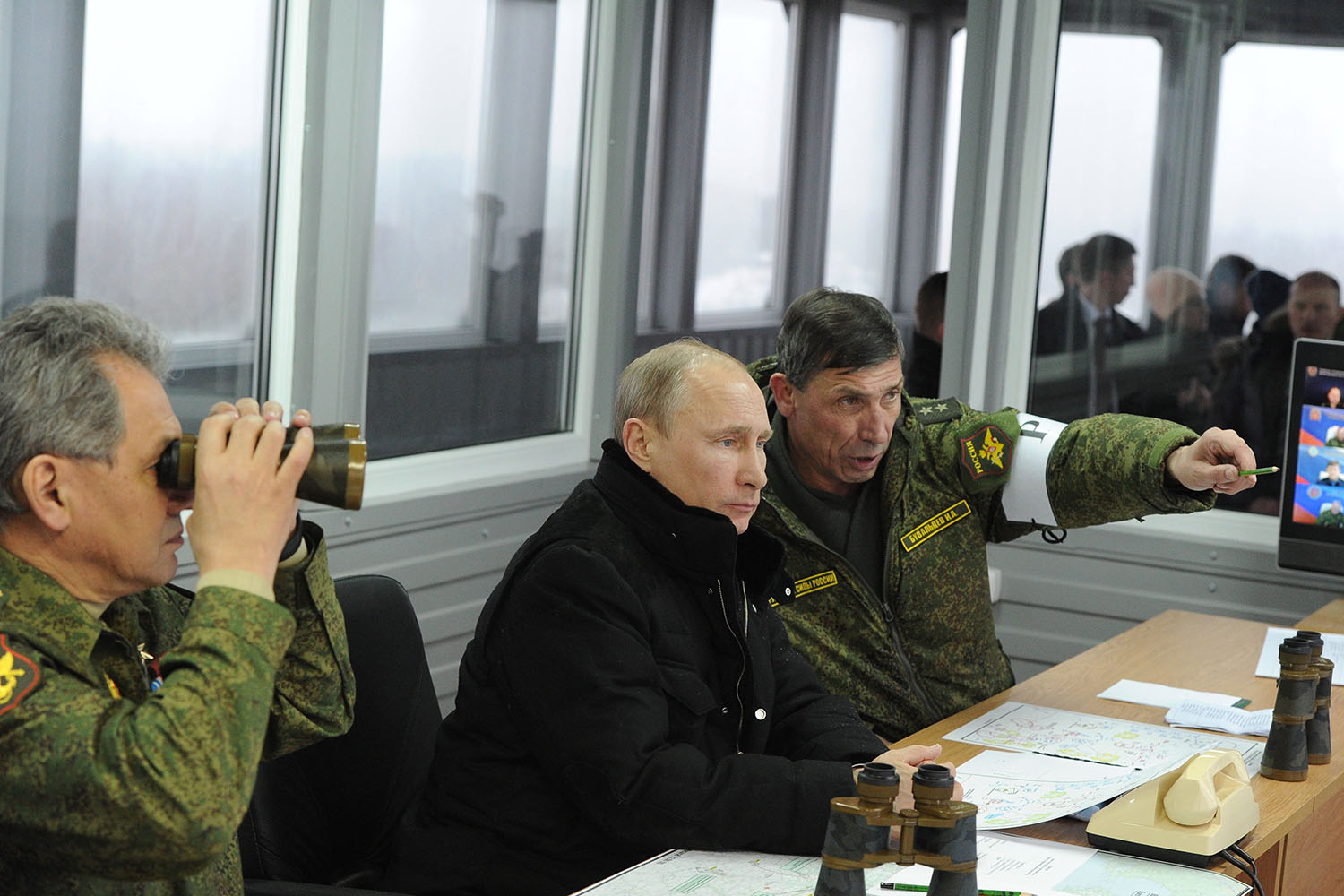 Mar. 3, 2014. Russia's defence minister Sergei Shoigu, president Vladimir Putin, and commander of the Russian Western Military District Troops Anatoly Sidorov (L-R) watch military exercises at the Kirillovsky training ground.