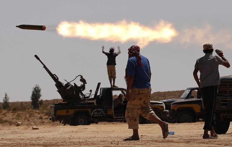 Anti-Gaddafi fighters fire a multiple rocket launcher near Sirte