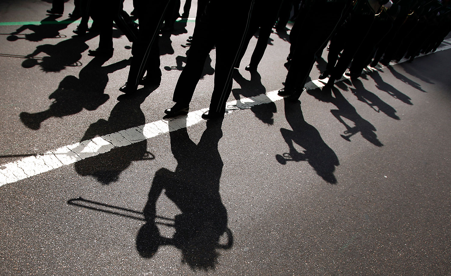 A marching band casts shadows on the road during the 251st annual St. Patrick's Day Parade in New York, March 17, 2012. (Carlo Allegri—Reuters)