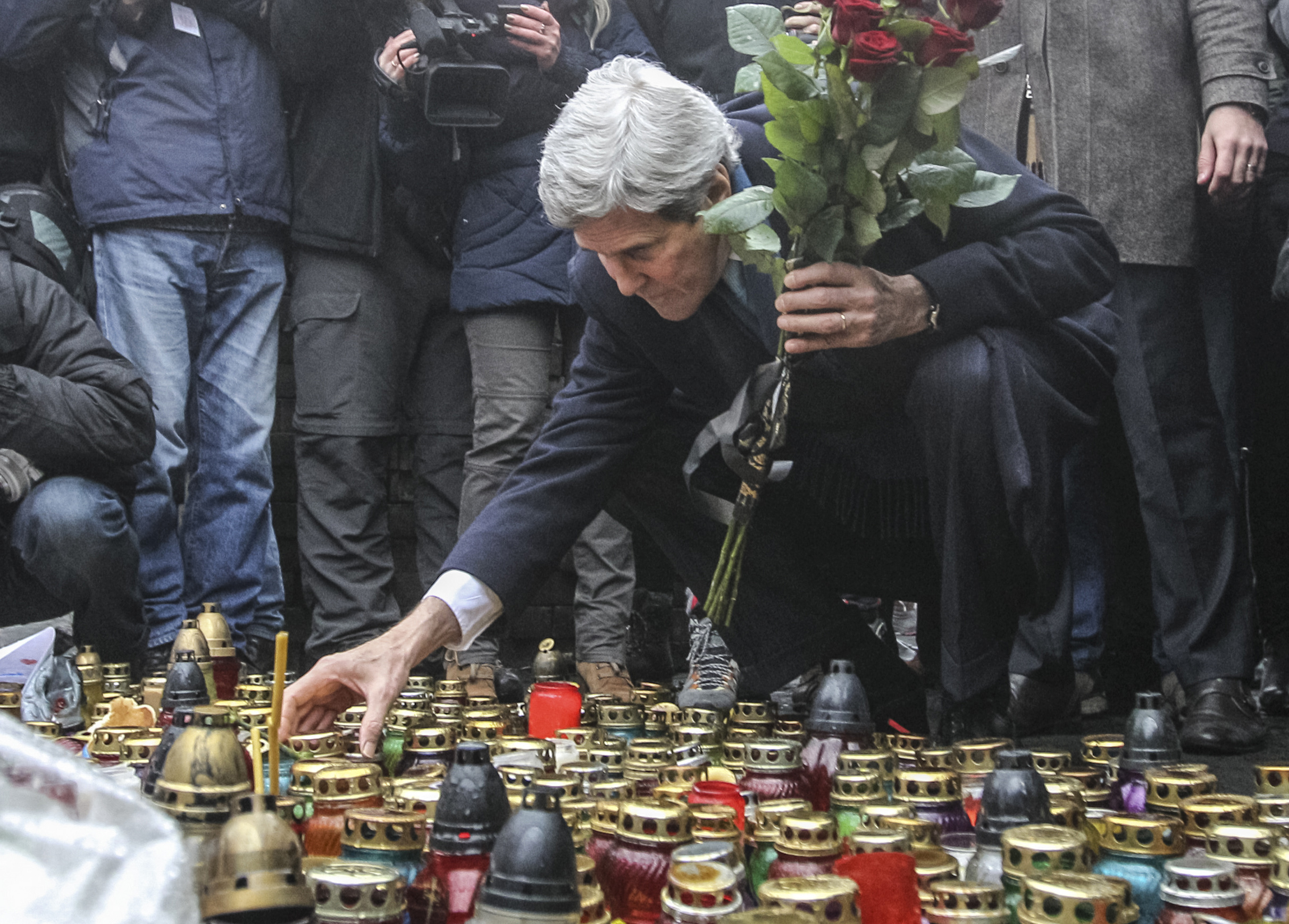 U.S. Secretary of State John Kerry lights a candle and lays roses atop the Shrine of the Fallen in Kiev March 4, 2014. (Valentyn Ogirenko—Reuters)