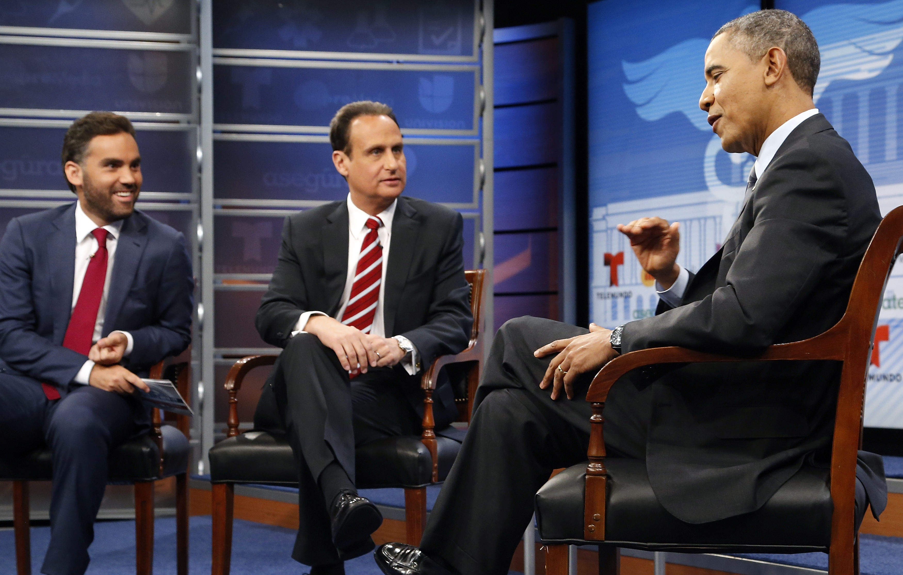 President Barack Obama talks with moderators Enrique Acevedo of Univision and Jose Diaz Balart of Telemundo during a commercial break in a town hall-style television forum to encourage Latino Americans to enroll in Obamacare health insurance plans, at the Newseum in Washington March 6, 2014. (Jonathan Ernst—Reuters)