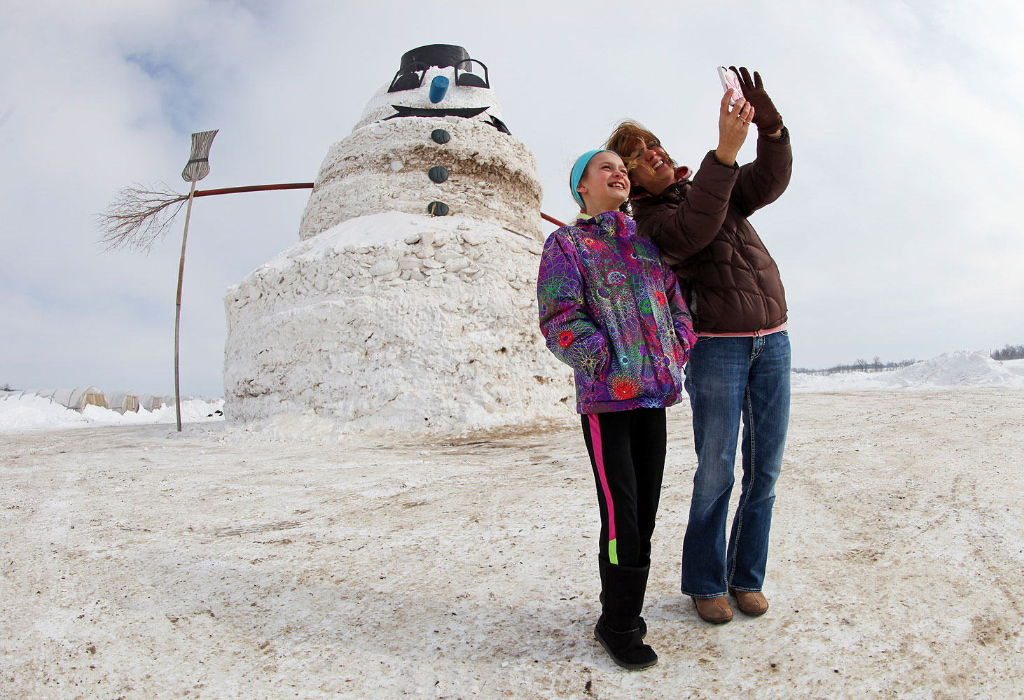 Mother and daughter photograph themselves in front of 50 foot snowman in Minnesota