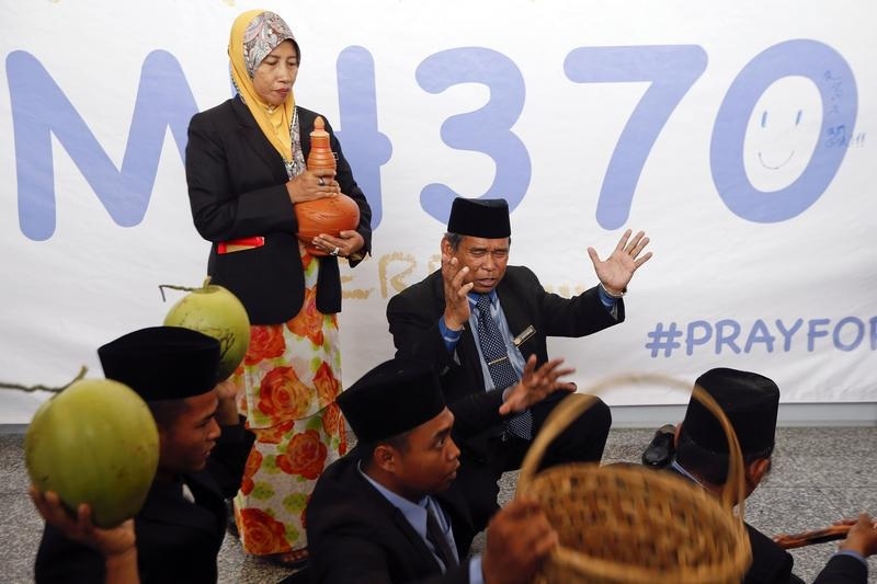 Ibrahim Mat Zin performs a ritual to help find the missing Malaysia Airlines MH370 at Kuala Lumpur International Airport. (© Damir Sagolj—Reuters)