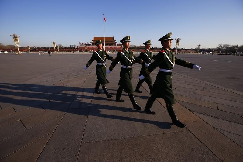 Paramilitary policemen march at the Tiananmen Square, near the Great Hall of the People, the venue holding the closing ceremony of the Chinese National People's Congress in Beijing