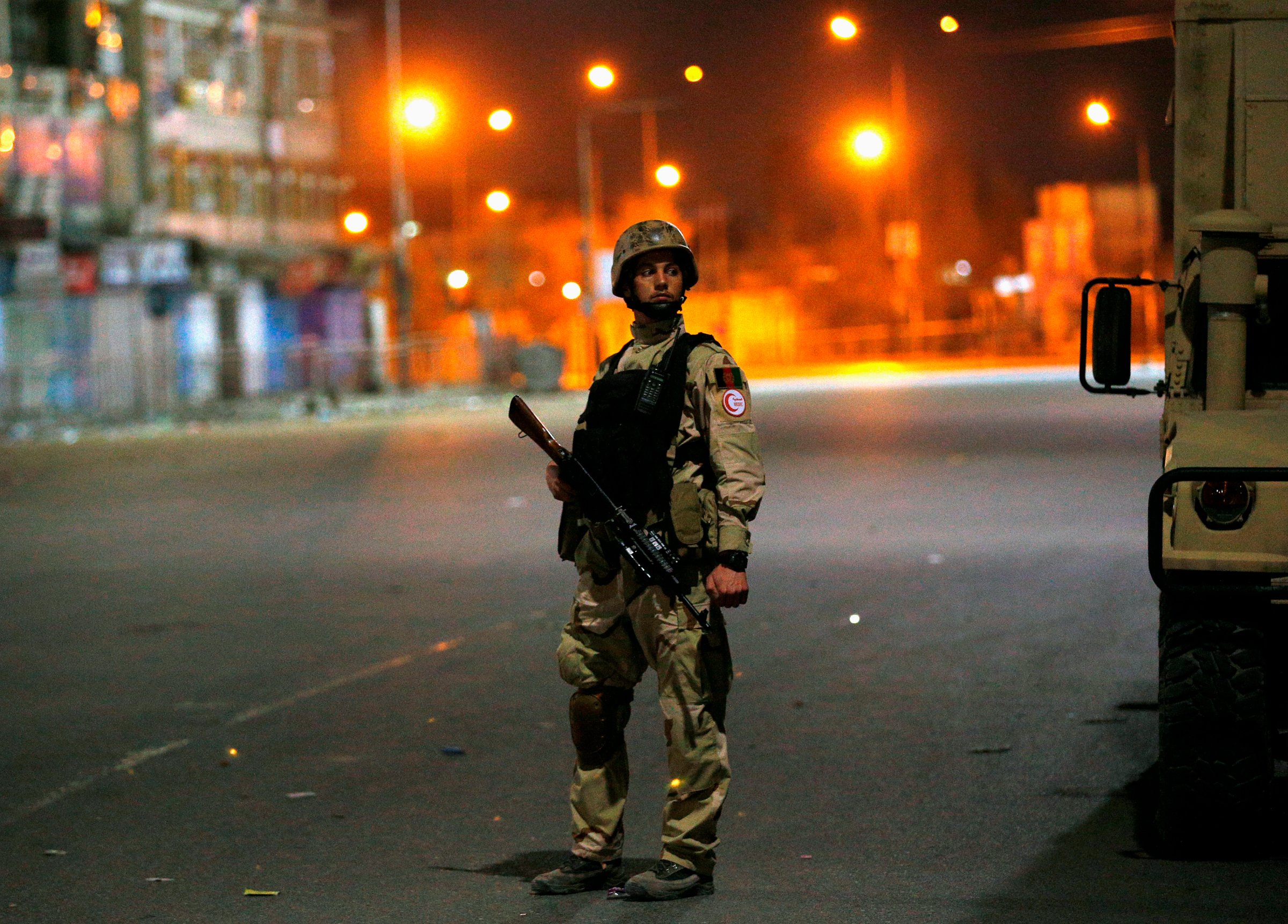 An Afghan security personnel keeps watch near the Serena hotel, during an attack in Kabul