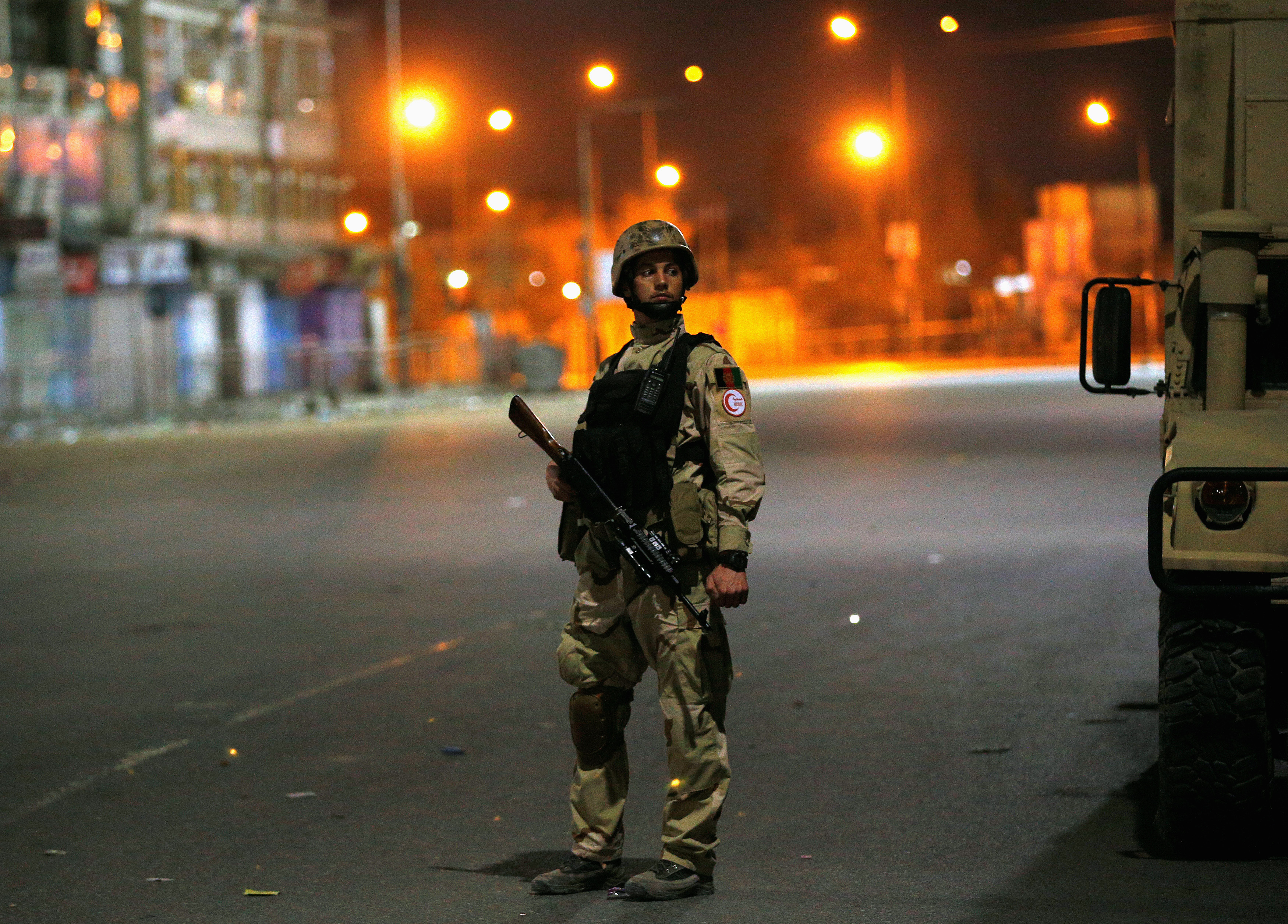 An Afghan soldier keeps watch near the Serena hotel, during an attack in Kabul, March 20, 2014. Taliban gunmen claimed nine lives. (Ahmad Masood—Reuters)