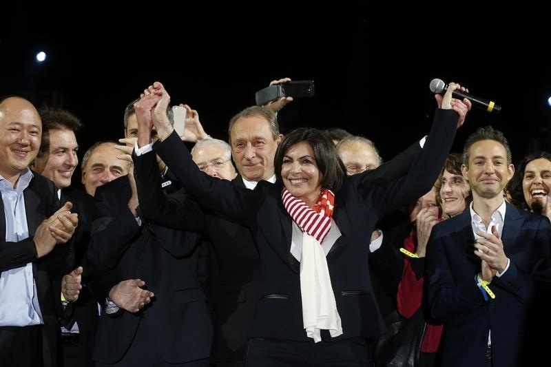 Former Mayor of Paris Bertrand Delanoe and his newly-elected successor Anne Hidalgo celebrate her victory at City Hall Plaza on March 30, 2014 in Paris.