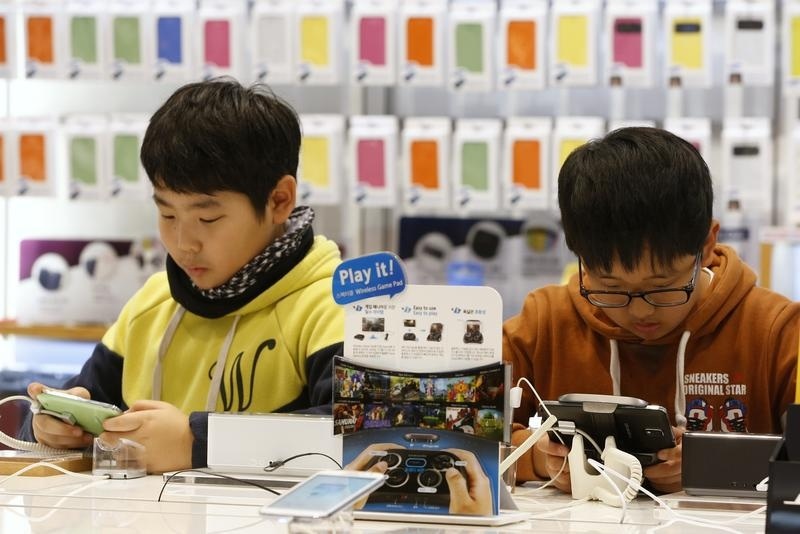People try out Samsung Galaxy phones at the Samsung Electronics' headquarters in Seoul