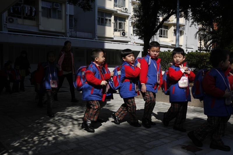 Students, who live in Shenzhen, leave their school at a public housing estate in Hong Kong, before crossing the border back to mainland China