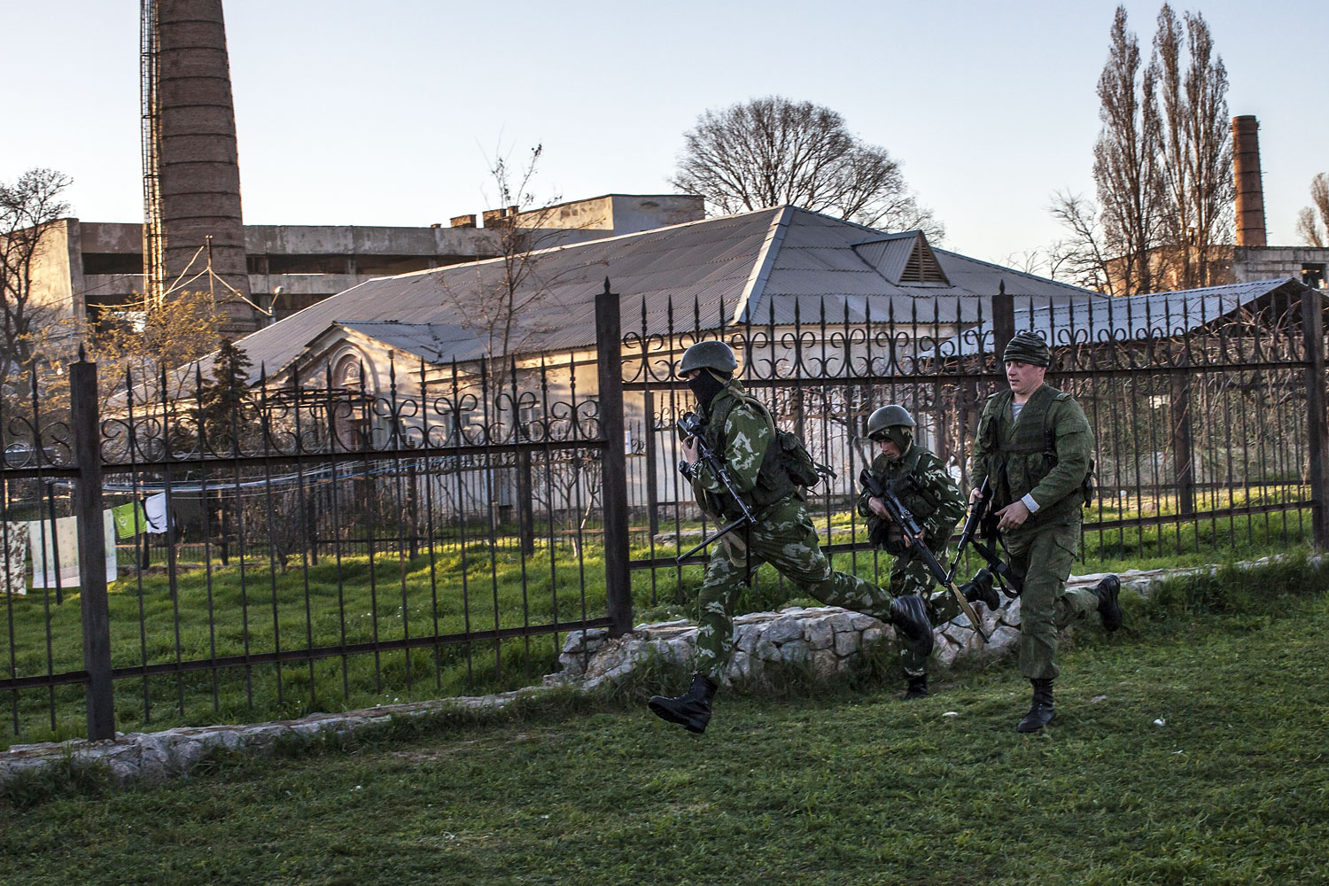 Russian forces storm a Ukrainian military base in the village of Belbek, Crimea.