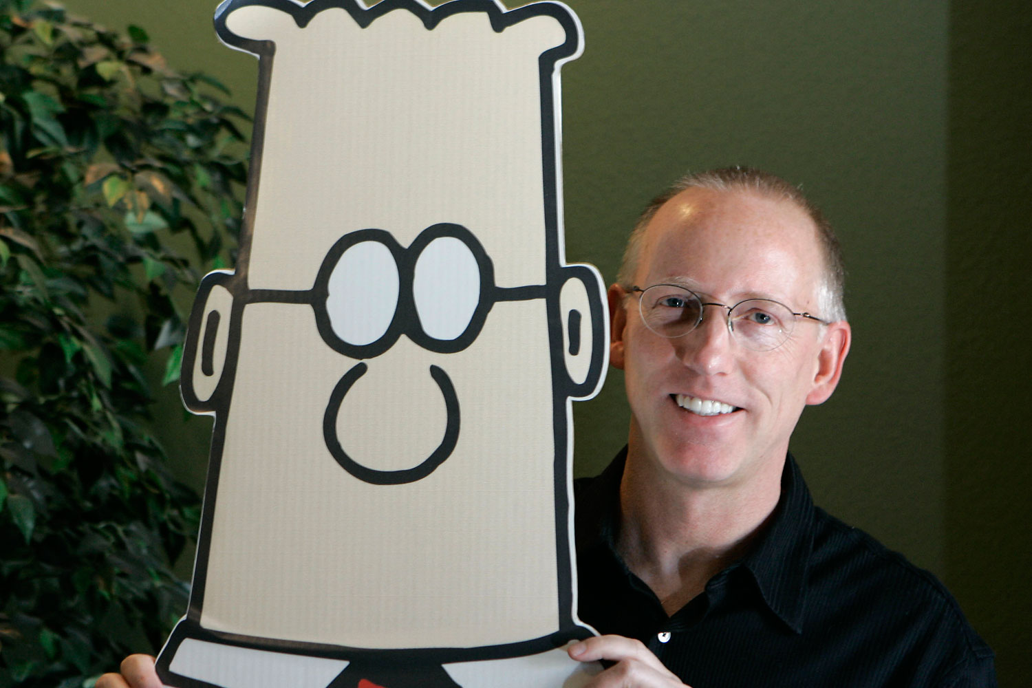 Scott Adams, creator of the comic strip Dilbert, poses for a portrait with the Dilbert character in his studio in Dublin, Calif., Thursday, Oct. 26, 2006. 