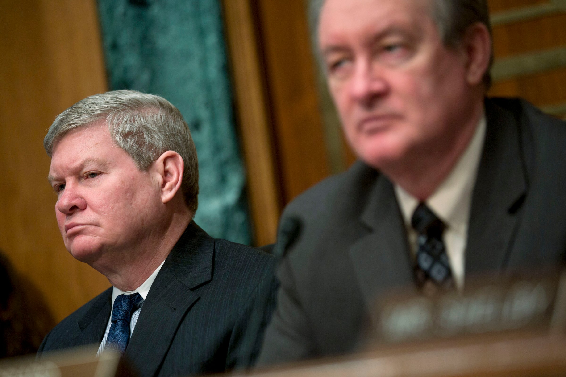 Senator Tim Johnson, chairman of the Senate Banking Committee, left, and Senator Mike Crapo listen during a Senate Banking Committee hearing in Washington, Feb. 27, 2014.