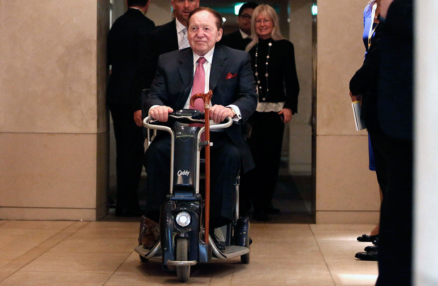 Las Vegas Sands Corp Chairman and Chief Executive Officer Sheldon Adelson rides his wheelchair after a news conference in Tokyo , Feb. 24, 2014 (Yuya Shino—Reuters)