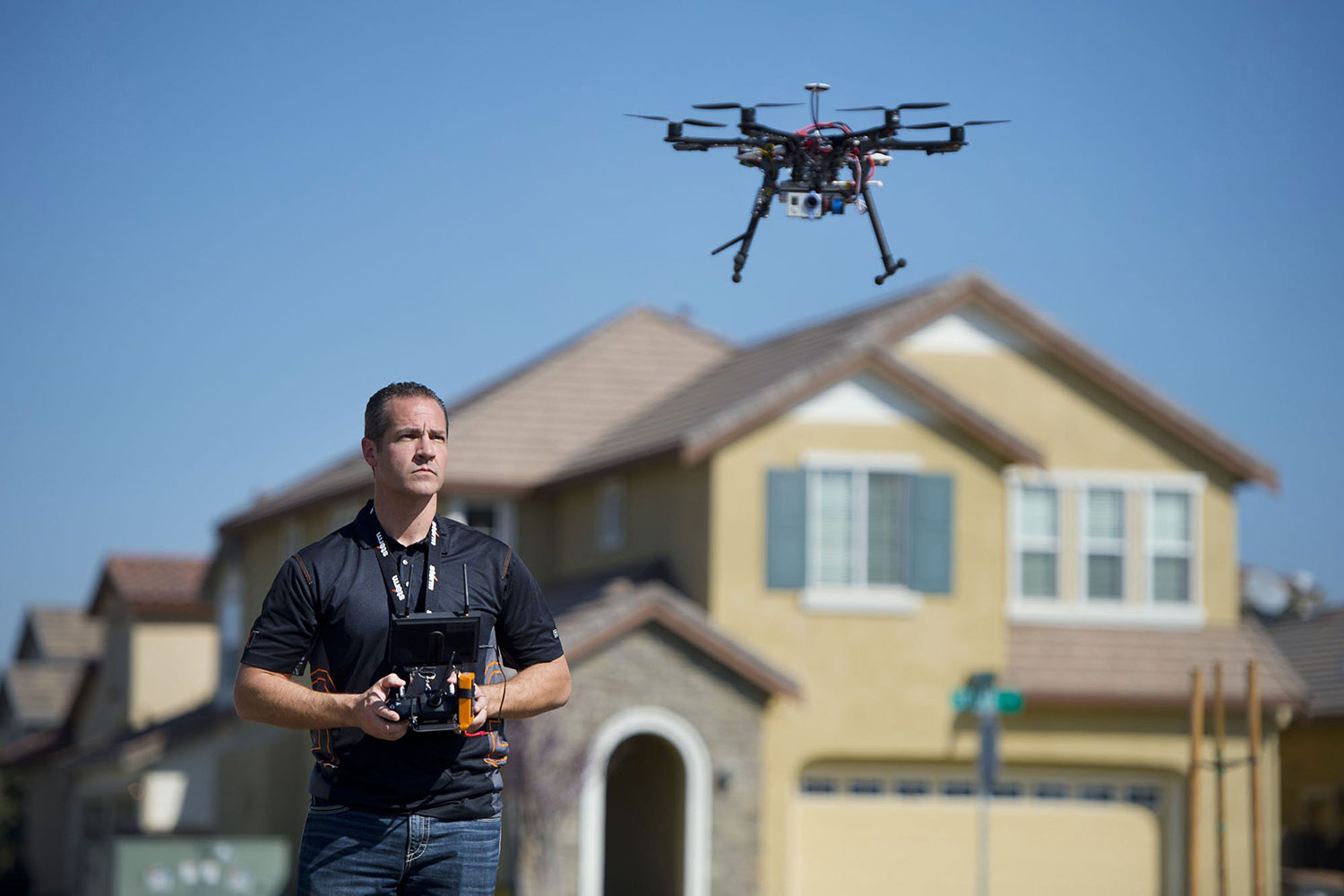 Christopher Brown, co-owner of Next New Homes Group, uses his multi-rotor helicopter drone to take aerial video of a home in Sacramento, Calif., on Feb. 25, 2014.
