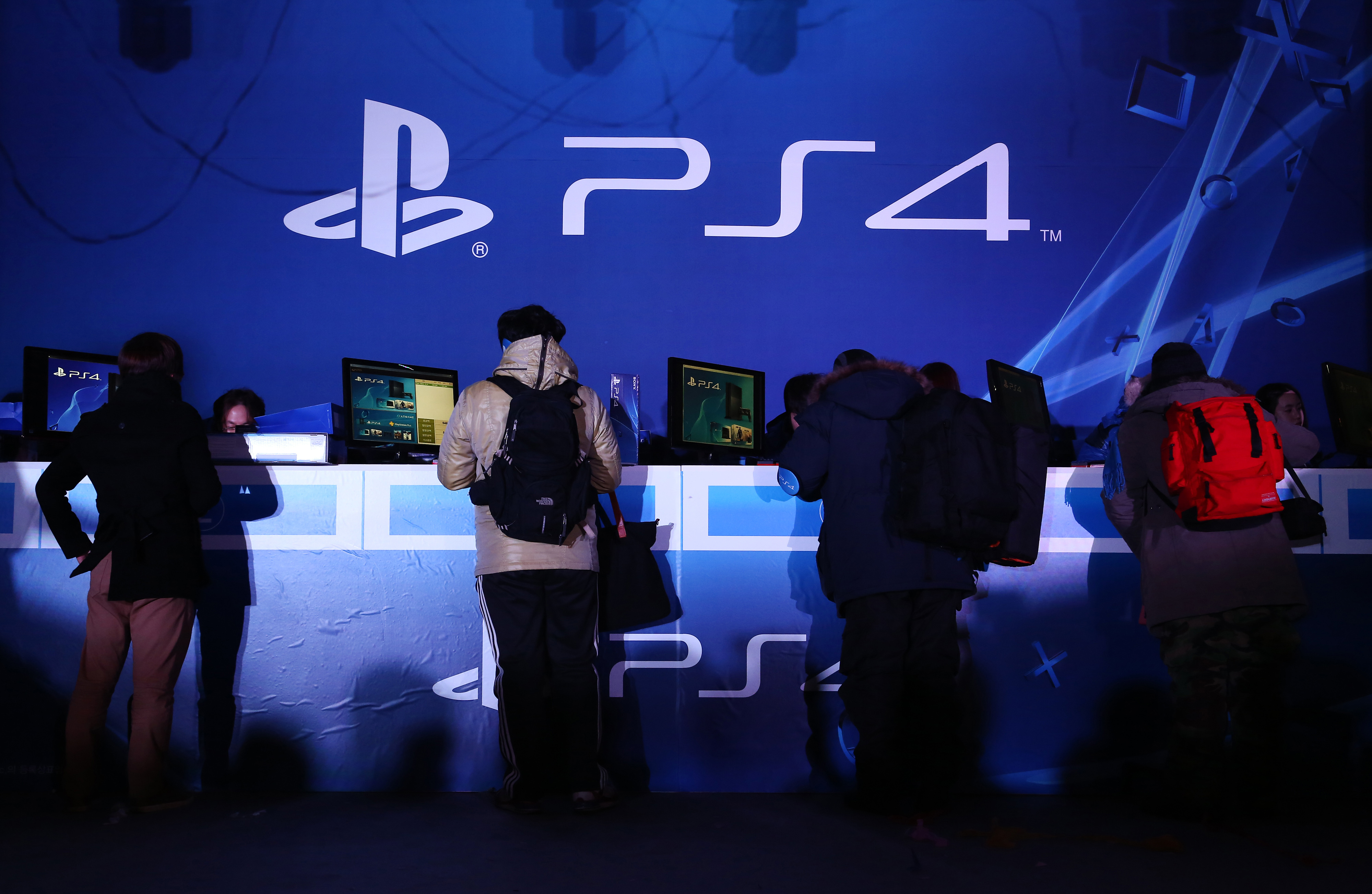 Customers buy Sony Computer Entertainment Inc.'s PlayStation 4 video game console box during the launch event in Seoul, South Korea, Dec. 17, 2013.