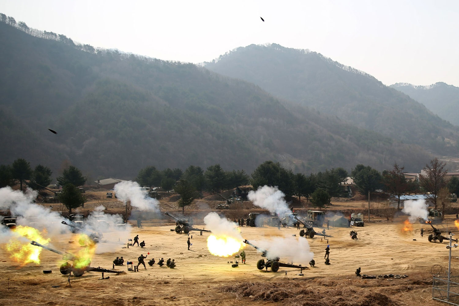 Towed 155mm Howitzers fire during an artillery drill in Inje near the demilitarized zone (DMZ) which separates the two Korea